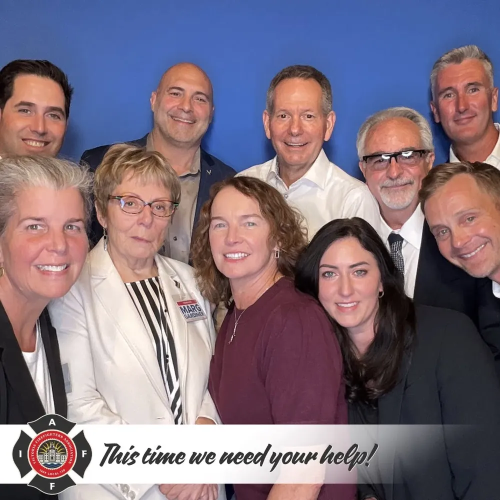 Group photograph from the Victoria Firefighters union's endorsement announcement: the endorsed candidates with union members, under the union badge and the line This time we need your help
